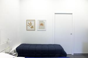 a bedroom with a blue bed and a door at di fronte al museo in Gela