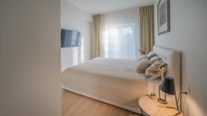 En eller flere senge i et værelse på Apartmán Donizetti D 10