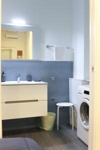 a bathroom with a sink and a washing machine at di fronte al museo in Gela +22 photos