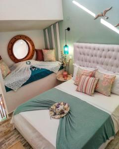 a bedroom with two beds and a mirror at Aelia House Chalkidiki in Fourka