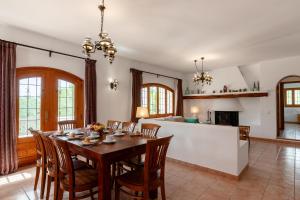 a kitchen and dining room with a table and chairs at New! Villa Can Bassetes in Can Furnet