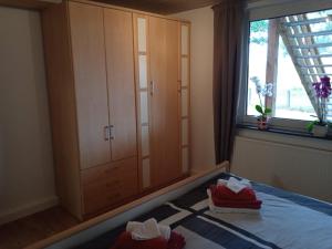 a bedroom with a bed and a cabinet and a window at FeWo 3 Griese in Damnatz