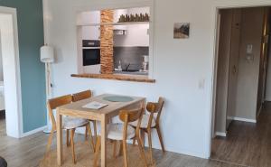 a dining room with a wooden table and chairs at Dünenrose Seegras Nr 41 in Norderney