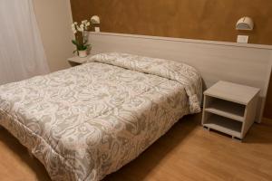 Postel nebo postele na pokoji v ubytování Hotel Cecco