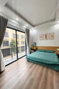 a bedroom with a bed and a large window at Emiii House -Homestay View Biển Vinhomes Ocean Park 2 in Hòa Bình