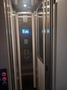 a elevator in a building with a clock on it at House Camogli in Camogli