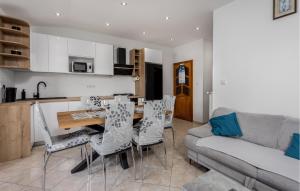 a kitchen and living room with a table and chairs at 2 Bedroom Beautiful Apartment In Lopar in Lopar