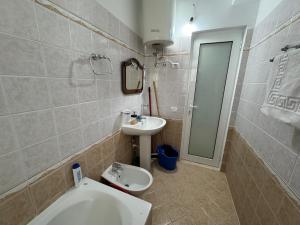 a bathroom with a toilet and a sink at Comfort Apartments Promenade in Sarandë