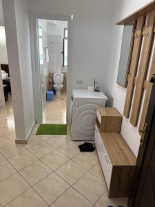 a bathroom with a sink and a toilet in a room at Comfort Apartments Promenade in Sarandë +37 photos