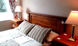 a bedroom with a bed and a table with a lamp at Ocean Lodge B&B in Renvyle