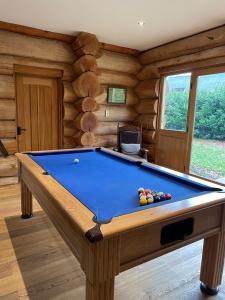 a room with a pool table in a cabin at Fir Lodge in Kings Lynn