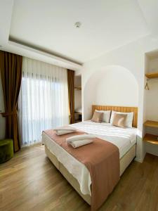a bedroom with a large bed and a large window at Marla Suite Fethiye in Fethiye +143 photos