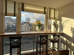 a window with a bar with chairs and a view of a city at Hotel Tourist Lviv in Lviv