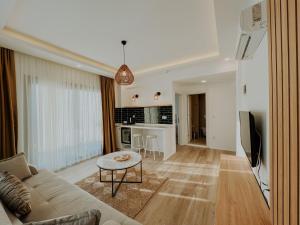 a living room with a couch and a table at Marla Suite Fethiye in Fethiye