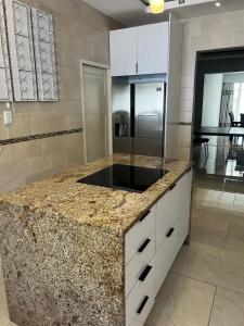 a kitchen with a granite counter top and a refrigerator at Josys Place in Bulawayo +45 photos