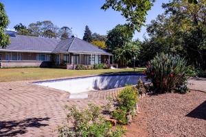 a house with a swimming pool in the yard at Josys Place in Bulawayo