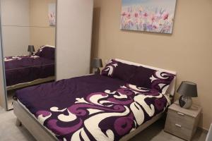 A bed or beds in a room at Seafront Studio Apartment