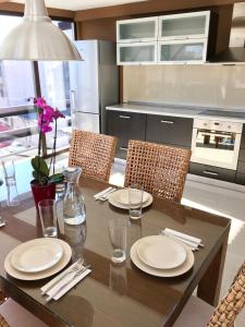 a kitchen with a wooden table with white plates on it at Elysium in Bucharest