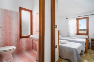 ブドーニにあるAppartamenti Lu Nibaruのトイレ、洗面台、ベッドのあるバスルーム