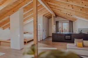 a large living room with a bed and a kitchen at Hofstatt Salzburg - Ferienwohnung in Söllheim