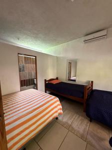 a bedroom with two beds and a mirror at Chalet brisas del mar in Chiquimulilla