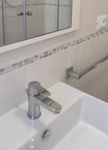 a bathroom sink with a faucet and a mirror at Villaggio Mietta in Castiglioncello