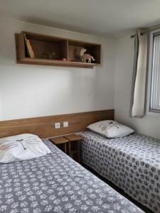 a room with two beds and a window at Mobil Home spacieux Camping Mar Estang 4* in Canet-en-Roussillon +36 photos