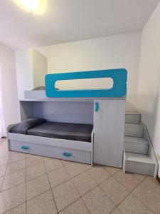 a bunk bed in a room with stairs at Villaggio Mietta in Castiglioncello