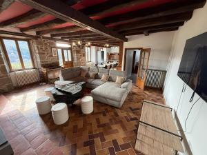 a living room with a couch and a table at La Maison du Colonel in Sainte-Eulalie