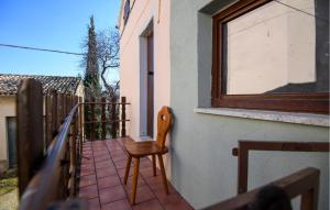 a wooden chair sitting on the balcony of a house at 2 Bedroom Lovely Home In Frontale in Frontale