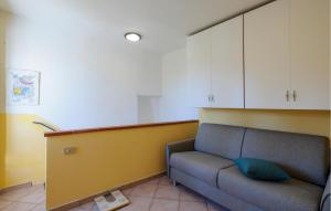 a living room with a couch and white cabinets at 2 Bedroom Lovely Home In Frontale in Frontale