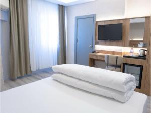 Postel nebo postele na pokoji v ubytování Optimal Hotel
