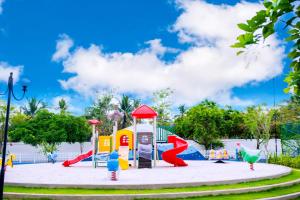 a playground with a slide in a park at Santorini 2BR Resort Apt - Negombo Beach & Airport in Negombo