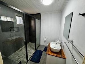 a bathroom with a shower and a toilet and a sink at Kitty Guest House in Bellville +97 photos