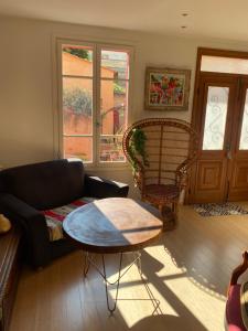 a living room with a couch and a table at Maison de ville avec jardin in Nice