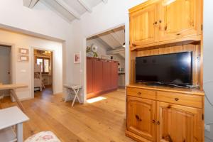 a living room with a large television on a wooden cabinet at Monte Pelmo in Alleghe