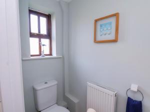 a bathroom with a toilet and a window at No 18 Riverside Walk Kingfisher in Whitby +33 photos