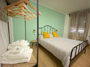 a bedroom with a bed with yellow pillows at Corte Prini Fiumicino in Fiumicino