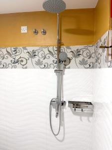 a shower in the corner of a bathroom at Lahiru Airport Villa in Andiambalama