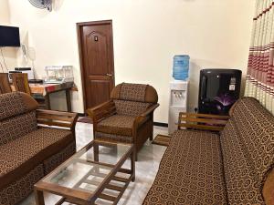 a living room with two chairs and a tv at Lahiru Airport Villa in Andiambalama +45 photos