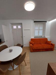 a living room with a couch and a table at Casa Bùgia Nen in Alba