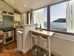 a kitchen with a counter and a large window at The Wash House in Torpoint