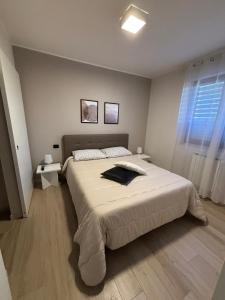 En eller flere senge i et værelse på PARCO VERDE APARTMENT