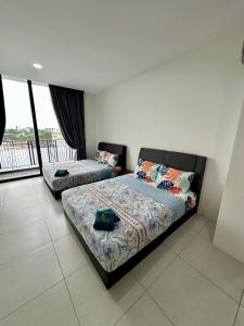 a bedroom with two beds and a balcony at Podium Premium 4 Bed Room in Kuching