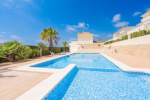 a swimming pool in front of a villa at CostaBlancaDreams Bungalow Gran Sol in Calpe in Calpe
