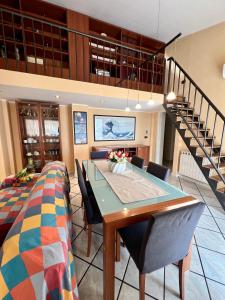 a dining room with a table and chairs and a staircase at Miramare - WelcHome in Fossacesia