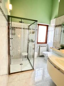 a bathroom with a glass shower and a toilet at Miramare - WelcHome in Fossacesia