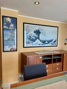 a room with a desk and a large painting on the wall at Miramare - WelcHome in Fossacesia +22 photos