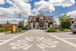 a house with a bicycle painted on the road at Aparthotel Góralski Spa 2 in Białka Tatrzańska