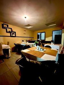 a restaurant with tables and chairs in a room at Dithabeng View Guest House in Rustenburg